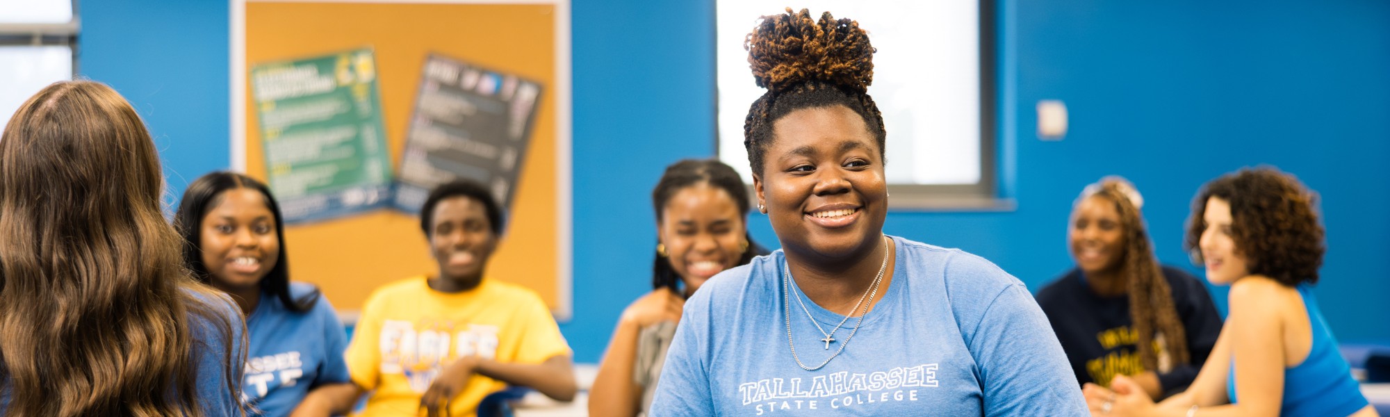 Students smiling in a classroom.