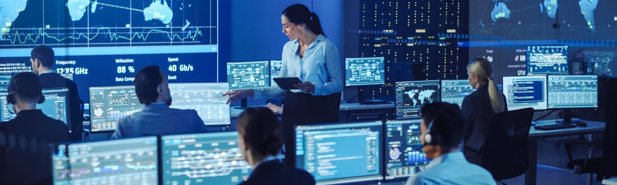 Employees working together in computer lab.