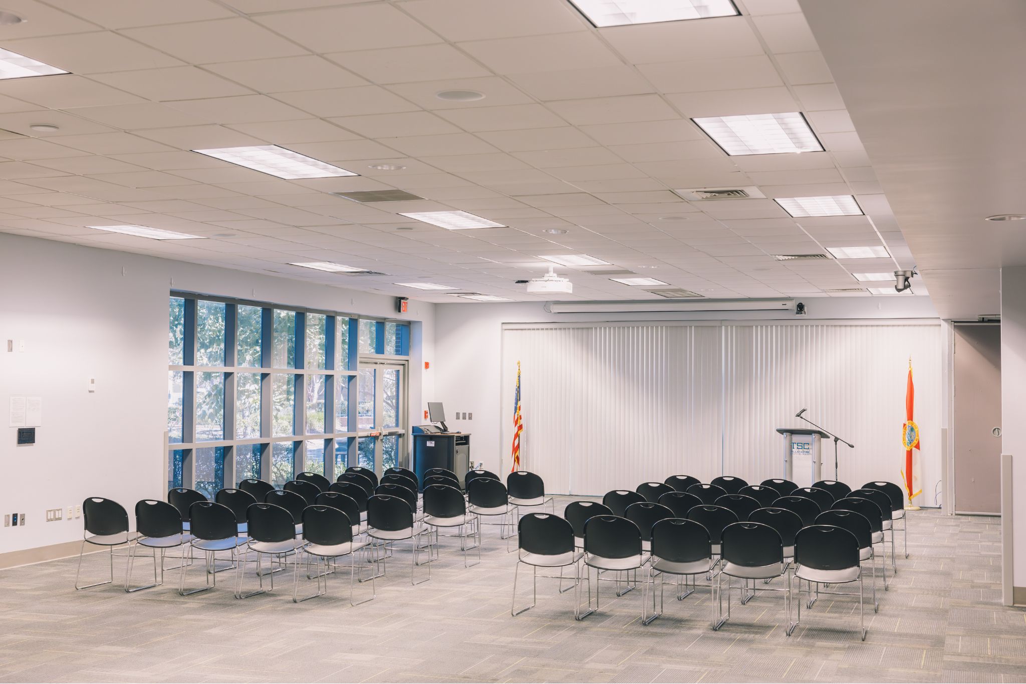 Student Union Ballroom filled with chairs. A podium is set up at the front of the room for a speaker.