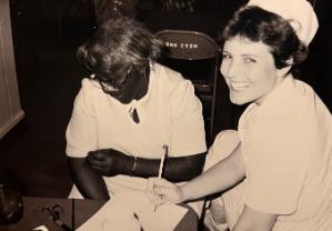 Black and white picture of a TSC dental student and faculty member.