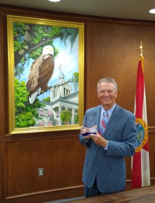 TCC Frank Messersmith 2021 AFC Trustee of the Year holding award. 