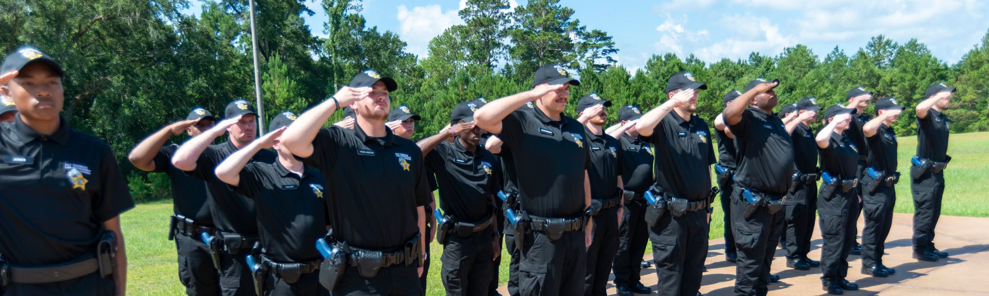Law student saluting the American flag.