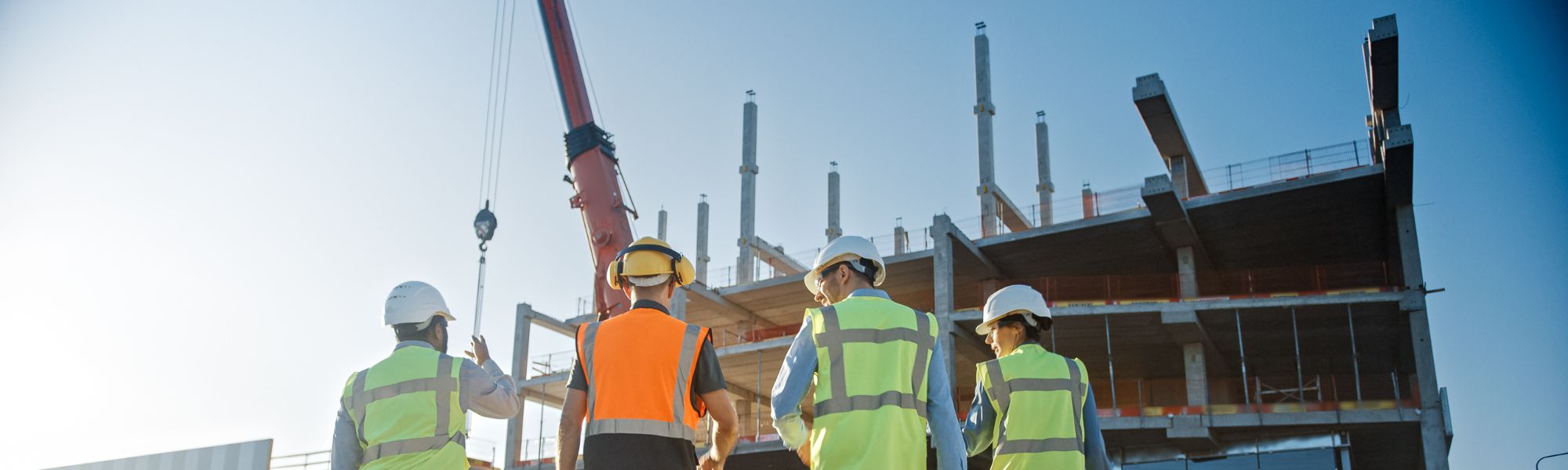 Construction Workers looking over half-built building